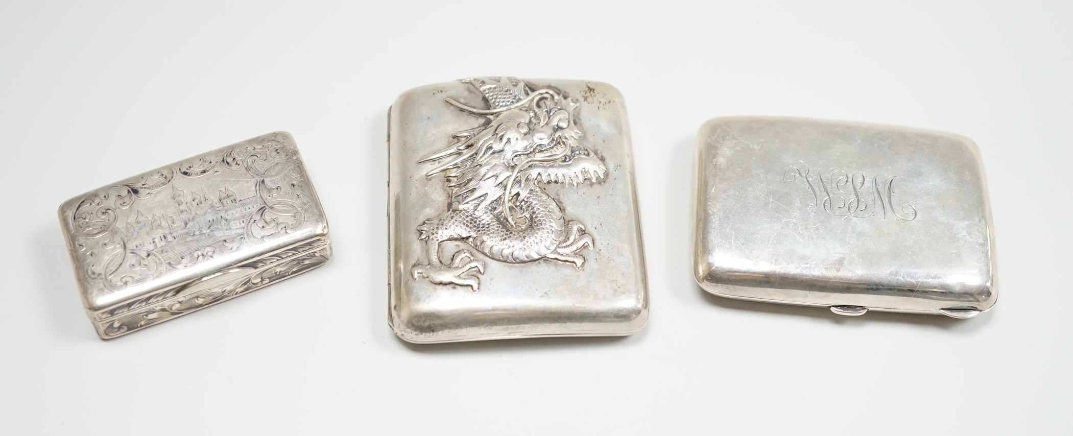 A white metal cigarette case, with applied dragon, 82mm, one other silver cigarette case and a Russian 84 zolotnik snuff box(tired).